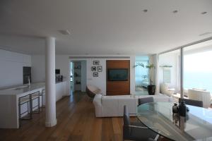 a living room with a white couch and a table at Sea Apartment in Netanya