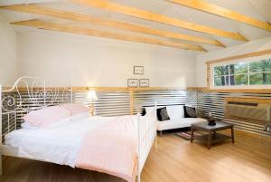 a bedroom with a white bed and a window at Expansive Vacation Lodge Rental for 60 Guests in Covington, Louisiana in Covington
