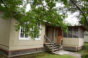 a small house with a porch and a door at Expansive Vacation Lodge Rental for 60 Guests in Covington, Louisiana in Covington