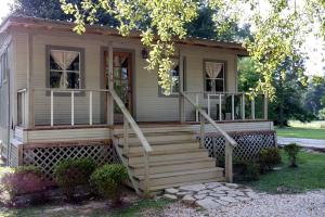 a house with stairs leading to the front door at Expansive Vacation Lodge Rental for 60 Guests in Covington, Louisiana in Covington