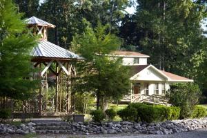 a large white house with a gazebo at Expansive Vacation Lodge Rental for 60 Guests in Covington, Louisiana in Covington
