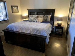 a bedroom with a large bed with pillows on it at Wimberley Romance: Escape to a Cozy Cabin Nestled in Nature, TX in Woodcreek