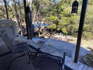 a bench sitting on a porch with a fountain at Wimberley Romance: Escape to a Cozy Cabin Nestled in Nature, TX in Woodcreek