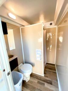 a small bathroom with a toilet and a shower at Lovely Safari Tent with River Access, Fire Pit and Barbecue in Staples, Texas in Staples