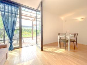 a dining room with a table and a glass door at 35 - Casa a due passi Dal mare Terrazza - Wifi - AC in Savona
