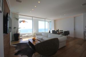 a living room with a white couch and a table at Sea Apartment in Netanya