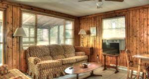 a living room with a couch and a tv at Deluxe Cabins for Rent near Lake Cumberland in Somerset, Kentucky in Bronston