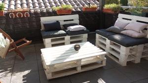 two benches sitting on a patio with pillows at Étage prive avec Chambre, salle de bain, terrasse in Avignon