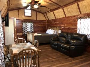 a living room with a couch and a bed at Comfortable Cabin Rental on a Winery for a Romantic Getaway in Oklahoma in Allen
