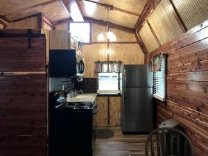a kitchen with a refrigerator and a stove at Comfortable Cabin Rental on a Winery for a Romantic Getaway in Oklahoma in Allen