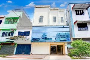 a group of buildings with a glass facade at OYO 94799 Siwah Hotel in Banda Aceh