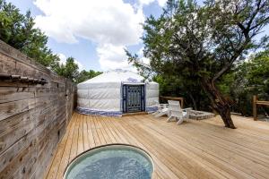 a yurt with a hot tub on a wooden deck at Secluded Romantic Yurt with Hot Tub in Wimberley, Texas in Cloptins Crossing