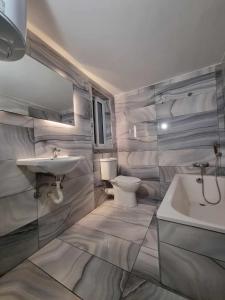 a white bathroom with a sink and a toilet at Stay by the Grand Harbour of Valletta in Senglea