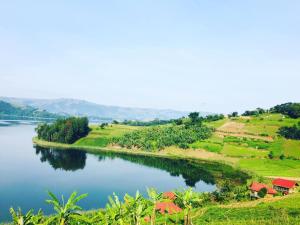 a view of a river with houses on a hill at One love archive in Chabahinga