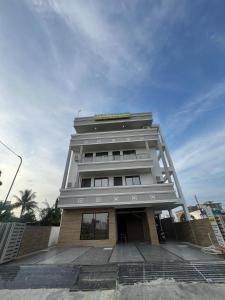 a tall building with a sign on top of it at Sukoon Grandeur in Jāmb +5 photos
