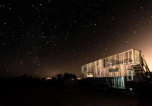 a building under a starry sky at night at Hand-Crafted Tiny House Getaway on Idyllic Dude Ranch in Sandy Valley, Nevada in Sandy Valley +7 photos