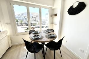 a dining room with a table and chairs and a window at Seaside getaway serenity and comfort in Palavas-les-Flots +10 photos