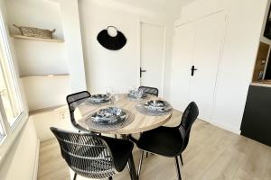 a dining room with a wooden table and chairs at Seaside getaway serenity and comfort in Palavas-les-Flots
