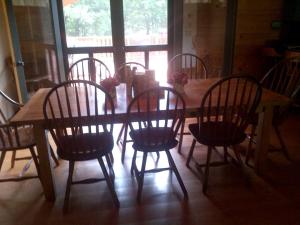 a wooden table with wooden chairs and a table and a table and a table at Bed and Breakfast Cabin for Weekend Getaway near Millbrook, New York in Dover Plains