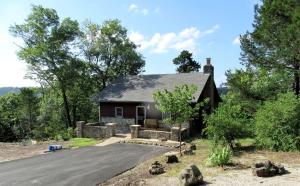 a small house with a road in front of it at Cozy Cabin Rental near Table Rock Lake in the Ozark Mountains, Missouri in Hollister