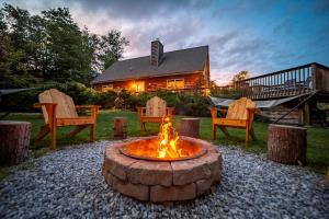 a fire pit in front of a house at Incredible New York Cabin with a Spa and Movie Theater in Livingston Manor
