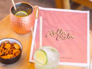 a table with a drink and a bowl of food at Mercure Nice Centre Notre Dame in Nice +148 photos