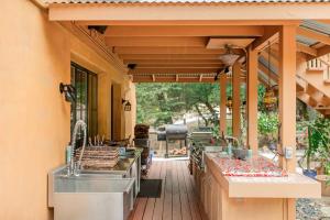 an outdoor kitchen with a wooden deck with awnings at Tranquil Yurt Rental for Two with Soothing Interior on Ranch near San Luis Obispo in Cayucos