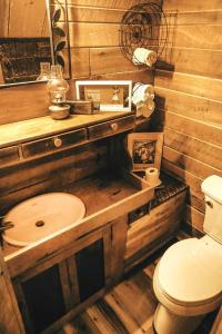 a bathroom with a wooden sink and a toilet at Luxury Cabin for Two with Beautiful River Views near Knoxville in Greeneville