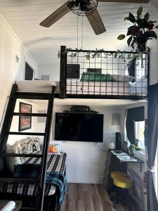 a room with a bunk bed and a desk at Remote Modern Tiny House with Deck, BBQ and Mountain Views in Arizona in Maricopa