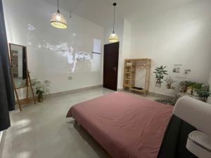 a bedroom with a large bed in a room at Nhi Homestay Rạch Giá in Rach Gia