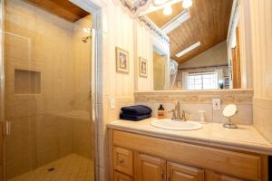 a bathroom with a sink and a shower at Romantic Log Cabin in the San Bernardino National Forest of California in Angelus Oaks