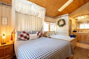 a bedroom with a bed and a bath tub at Romantic Log Cabin in the San Bernardino National Forest of California in Angelus Oaks