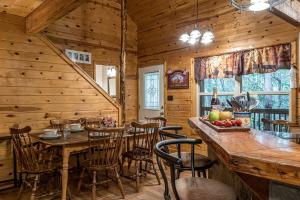 a dining room with a table and chairs in a cabin at Secluded Cabin with Hot-tub and Fire Pit in Cleveland, Georgia in Kinseytown +28 photos
