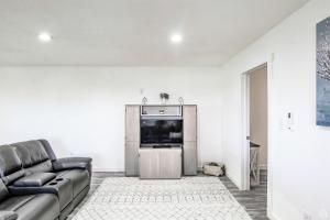 a living room with a couch and a flat screen tv at Incredible Cottage Close to Fantastic Hiking Trails Blanding, Utah in Blanding