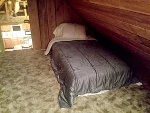 a bed in a room with a wooden wall at Cozy Vacation Rental with High-Speed Wi-Fi near Seven Springs, Pennsylvania in Champion