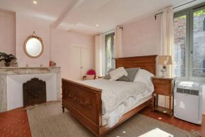 a bedroom with a bed and a fireplace at Peaceful apartment near Saint-Tropez in La Garde-Freinet