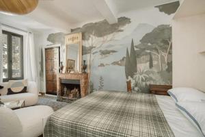 a bedroom with a bed and a painting on the wall at Peaceful apartment near Saint-Tropez in La Garde-Freinet