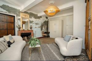 a living room with two white couches and a fireplace at Peaceful apartment near Saint-Tropez in La Garde-Freinet +11 photos