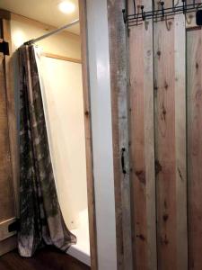 a room with a curtain and a closet with wooden walls at Intimate Yurt Rental Ideal for Romantic Glamping in Virginia in Rich Creek