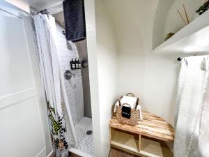 a bathroom with a walk in shower and a wicker basket at Colorado Caravan Experience: Airstream Adventure Under the Stars in Grand Junction in Grand Junction