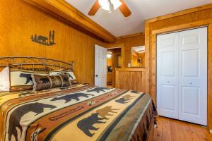 a bedroom with a bed in a room with wooden walls at Creekfront Cabin Amazing for Families in Helen, Georgia in Helen