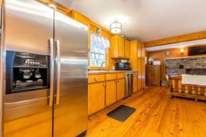 a kitchen with a stainless steel refrigerator at Creekfront Cabin Amazing for Families in Helen, Georgia in Helen
