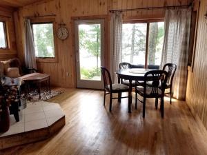 a dining room with a table and chairs at Idyllic Lake Cabin for a Camping Getaway in Cross Wing County, Minnesota in Emily