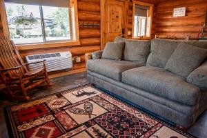 a living room with a couch and a rug at Luxury Pet-Friendly 1-Bedroom Log Cabin in Bonners Ferry with Full Kitchen and Wi-Fi in Bonners Ferry
