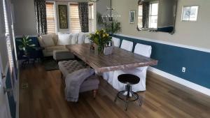 a living room with a table and a couch at Beautiful Waterfront Cottage Rental with a Pool near New Orleans, Louisiana in Slidell