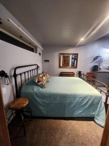 a bedroom with a bed with a green bedspread at Brand New, Modern Country Cabin near Bryce Canyon National Park, Utah in Cannonville