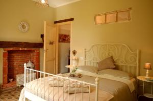 a bedroom with a bed and a fireplace at Bed & Tours Dimora di campagna in Castelnuovo Belbo +111 photos