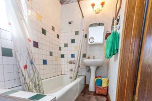 a bathroom with a sink and a tub and a toilet at Rustic Cabin Rental Perfect for Families in Texas Hill County in Marble Falls