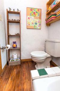a bathroom with a toilet and a wooden floor at Rustic Cabin Rental Perfect for Families in Texas Hill County in Marble Falls +12 photos