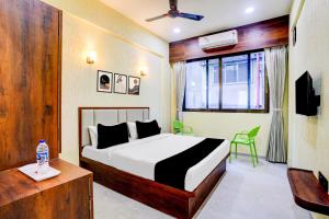 a bedroom with a bed and a table and a window at Super Collection O Kalamboli New Panvel Formerly Golden Paradise in Kalamboli +66 photos